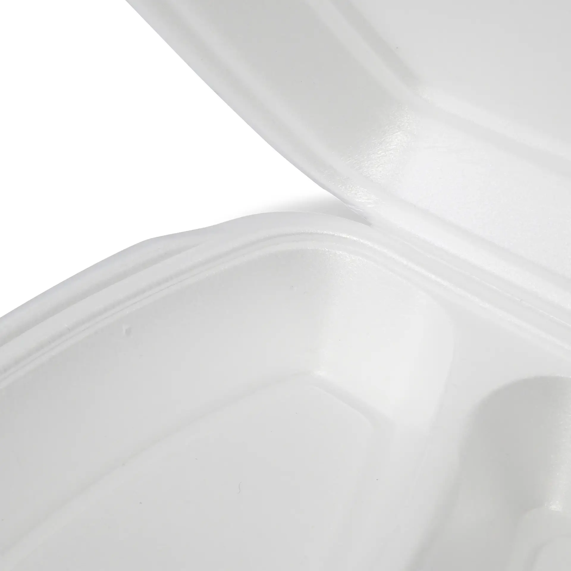 Contenant alimentaire clamshell blanc avec couvercle à charnière, montrant la vue intérieure et surface texturée.