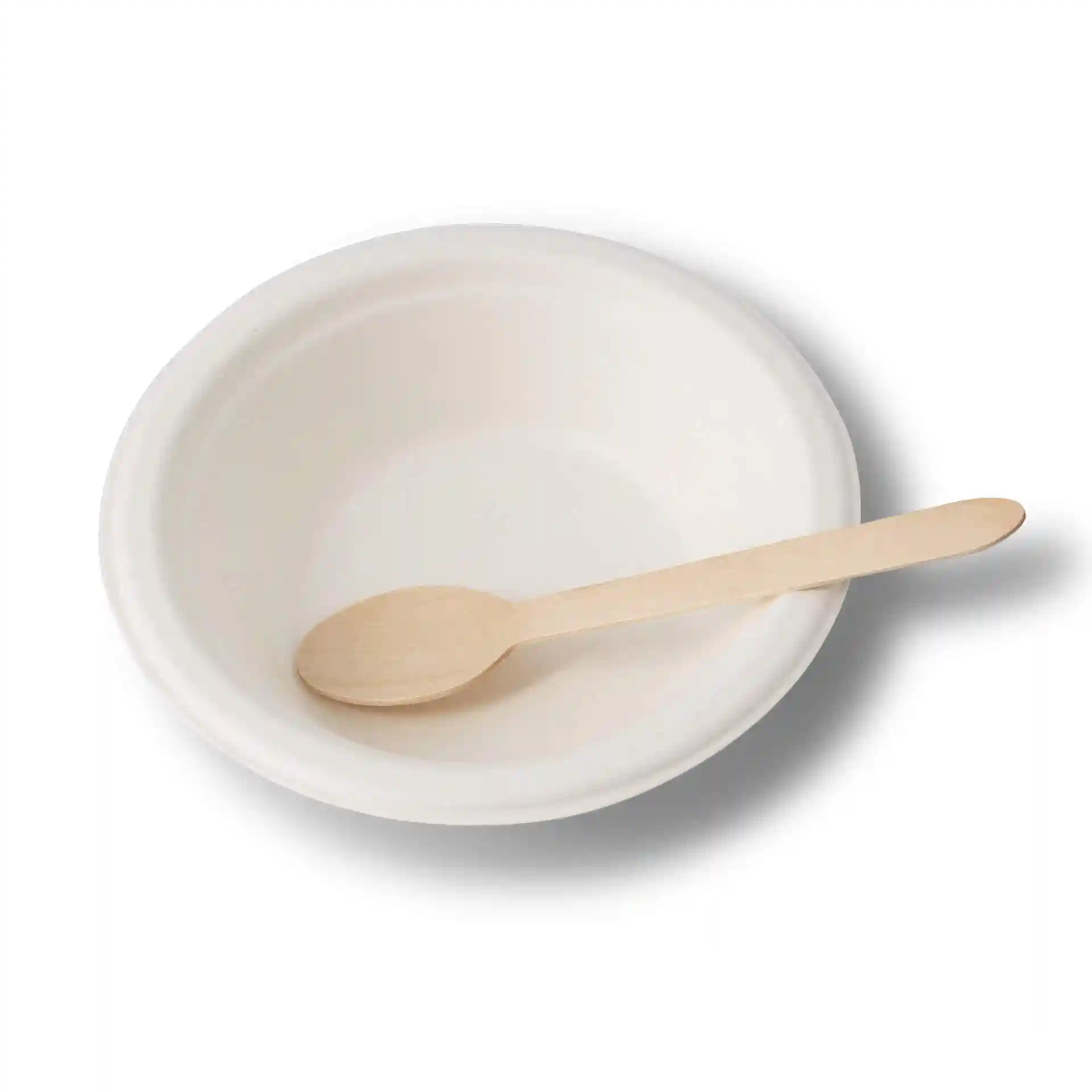 Bol rond en canne à sucre blanc avec une cuillère en bois à l'intérieur, dimensions 160 mm de diamètre et 40 mm de hauteur.