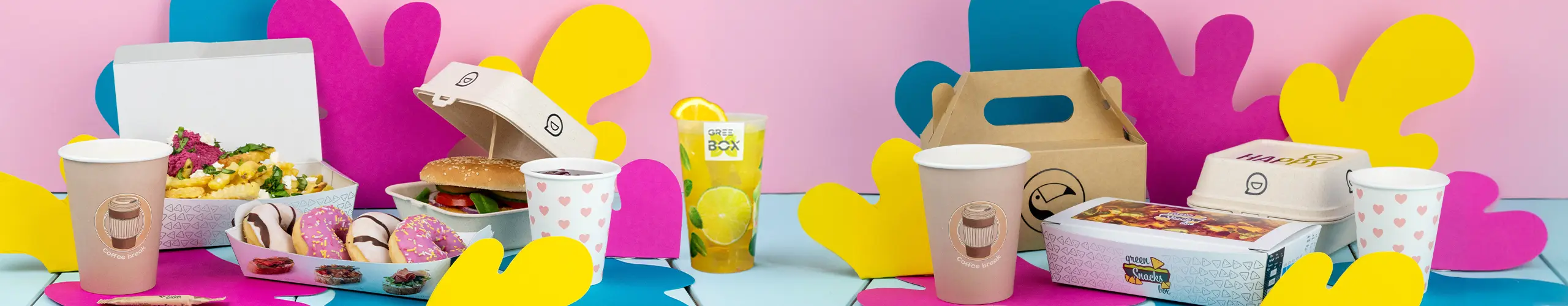 Assortiment d'aliments comprenant un hamburger, des frites, des donuts et des boissons, présentés avec des découpages en papier colorés sur une table.