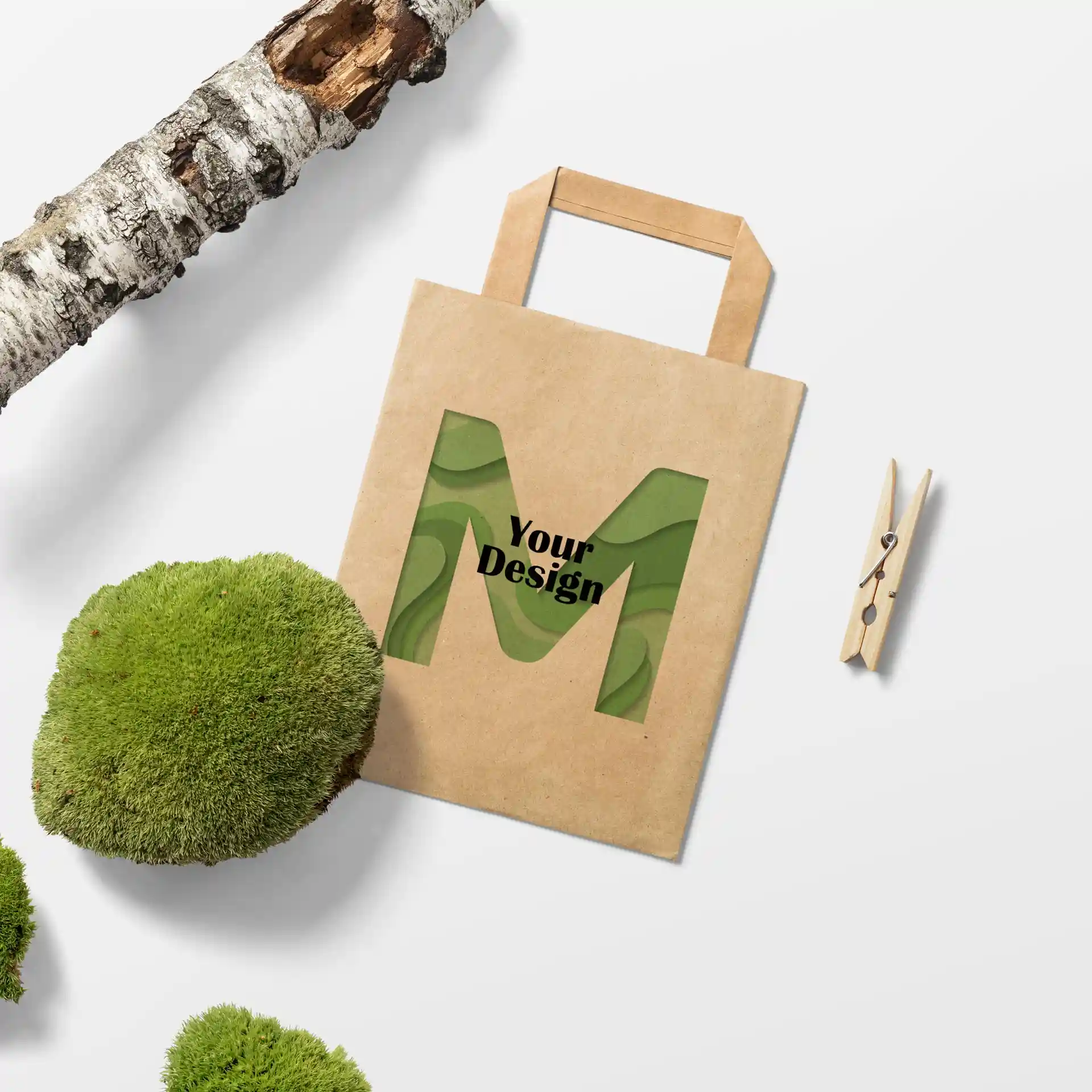 Sac en papier brun de forme rectangulaire, avec un design découpé de la lettre 'M' et la phrase 'Votre Design'.