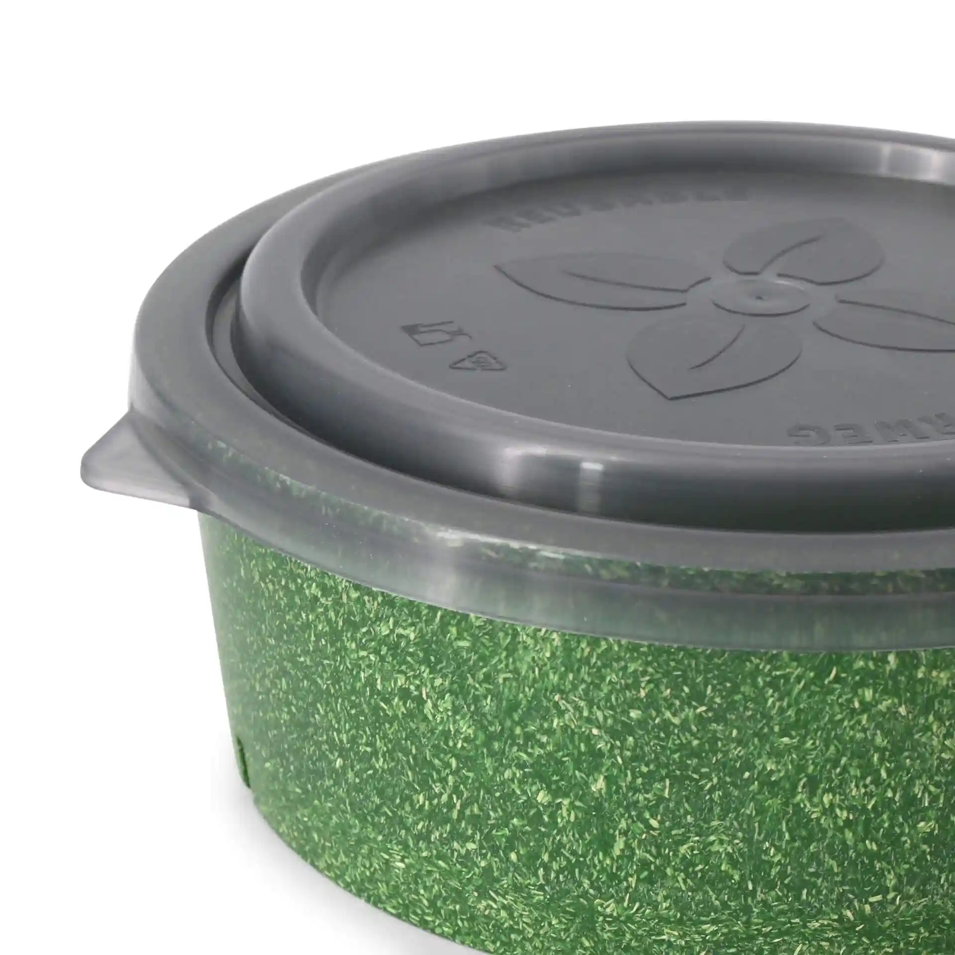 Bol rond avec un extérieur vert et un couvercle gris, présentant un design floral et des motifs sur le couvercle.