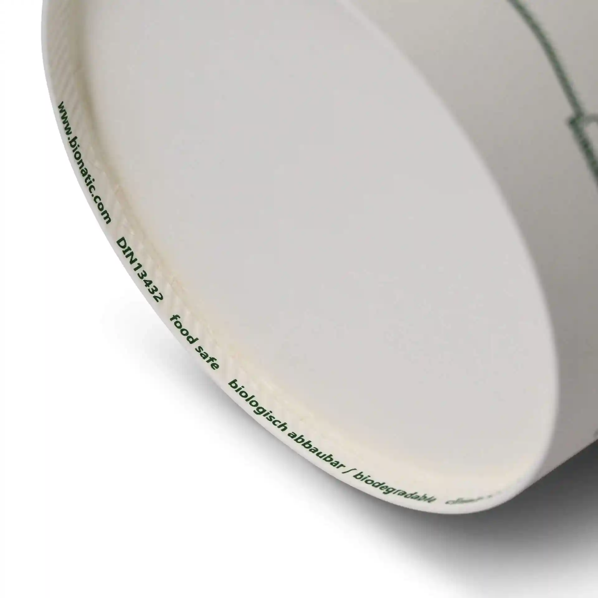 Conteneur rond en carton pour soupe avec un design imprimé, montrant le bord inférieur et les marquages.