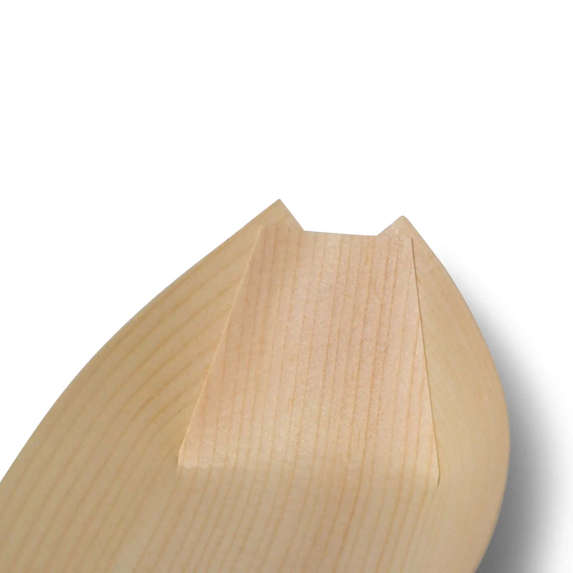 Gros plan de l'extrémité d'un objet en bois en forme de bateau avec une extrémité plate et une surface lisse.