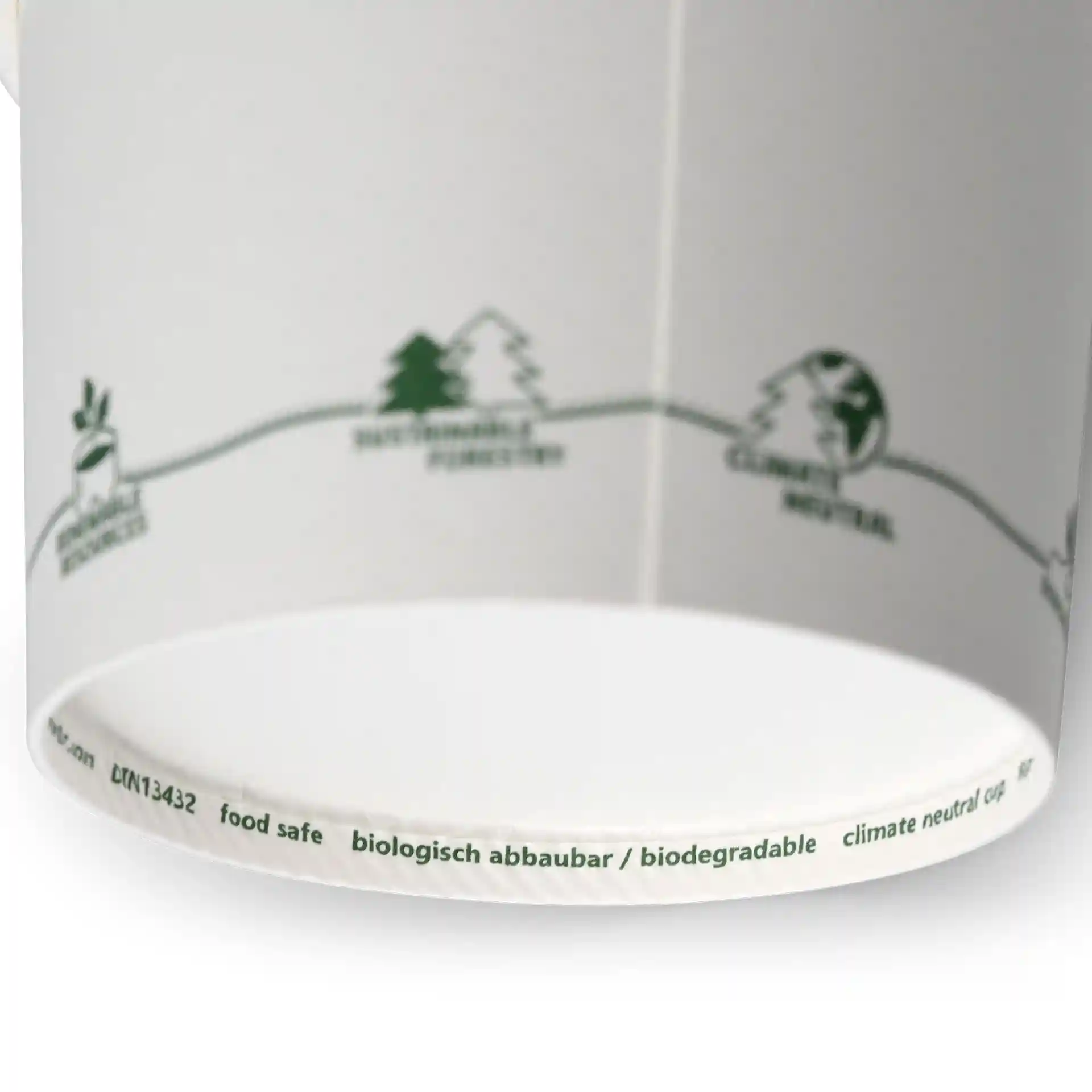 Bol en carton rond avec des icônes écologiques imprimées et un intérieur blanc, montrant divers symboles verts sur le bord.