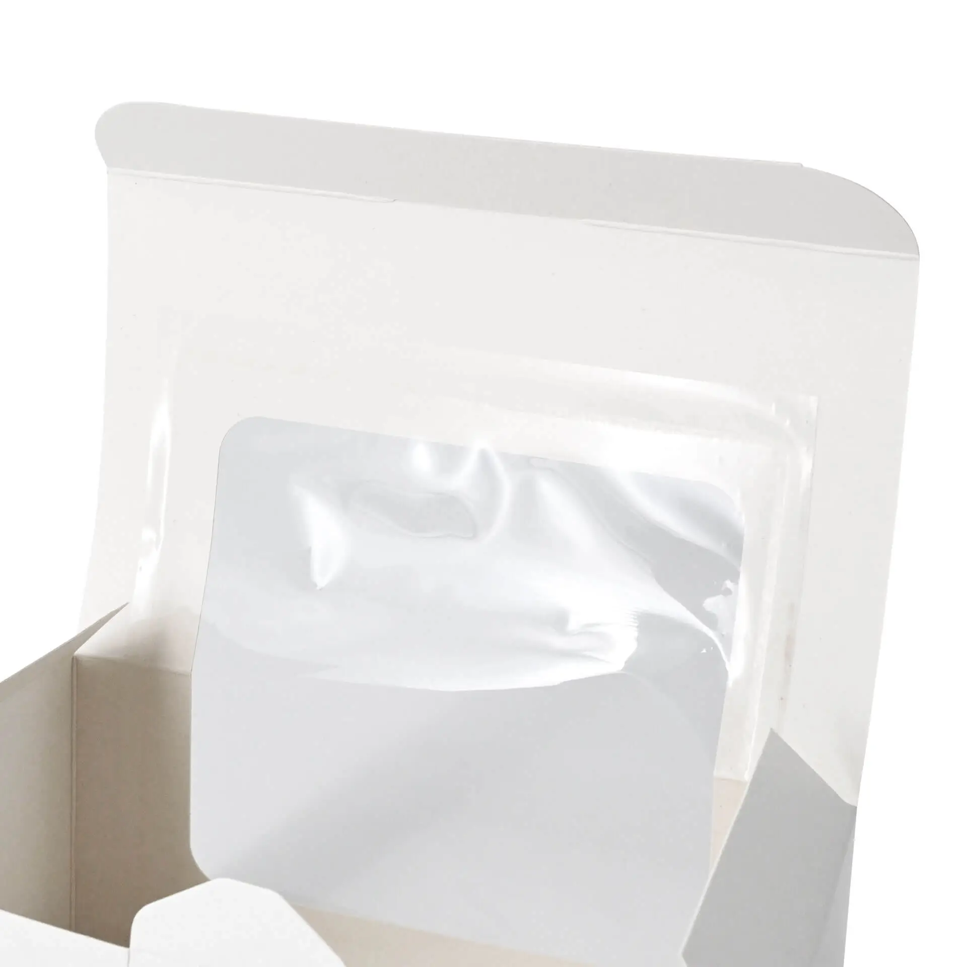 Boîte à cupcakes blanche avec une fenêtre en cellulose et deux compartiments pour les pâtisseries à l'intérieur.