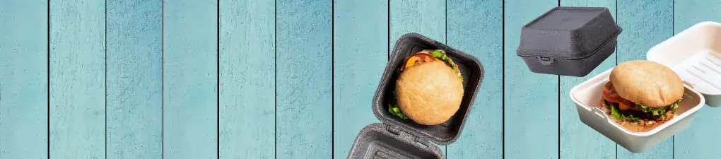 Personnage de chef cartoon vert avec une cuillère, à côté d'un burger dans une boîte à emporter brune sur un fond en bois bleu.