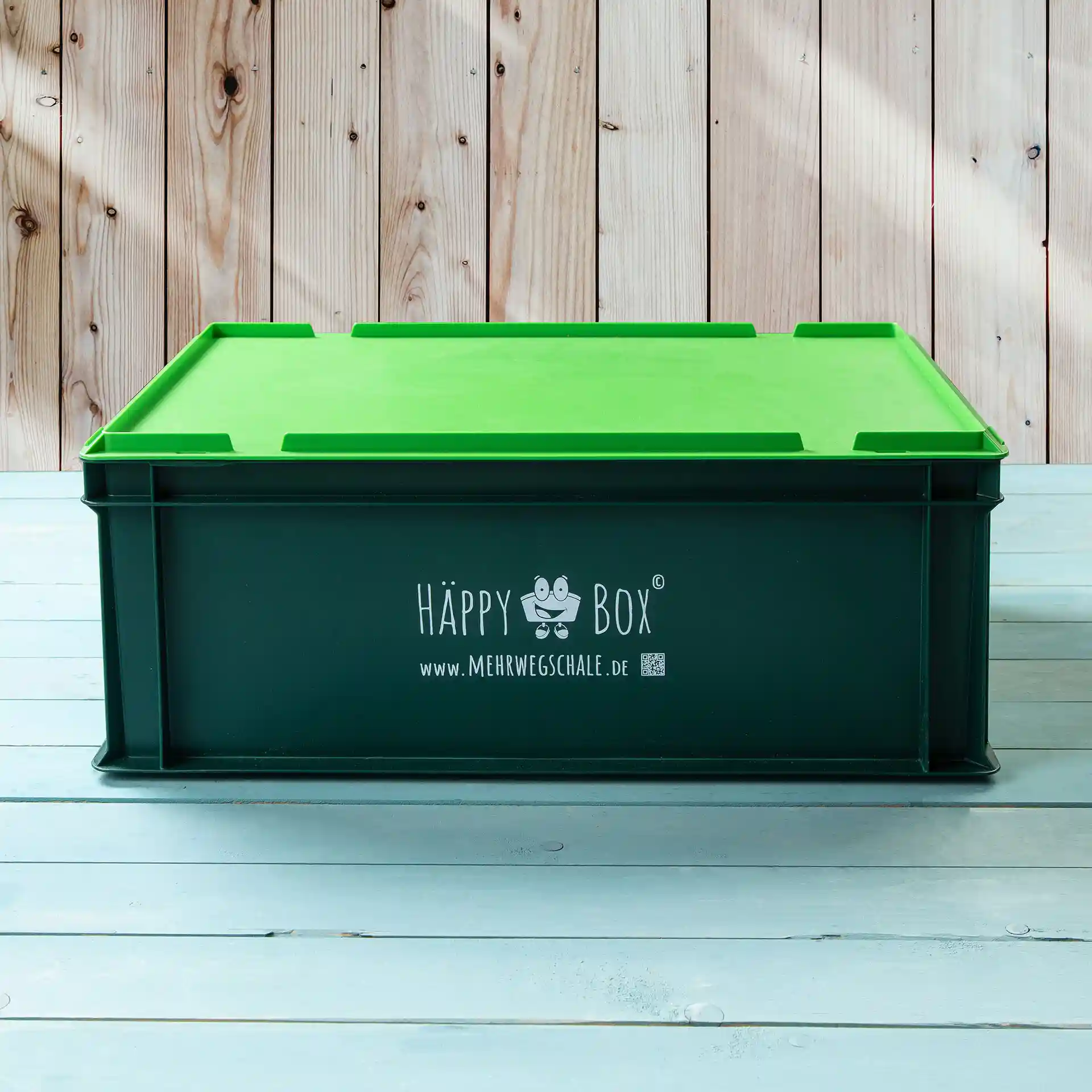 Boîte de rangement avec un couvercle vert et un corps vert foncé, avec un logo et un site web sur un côté.