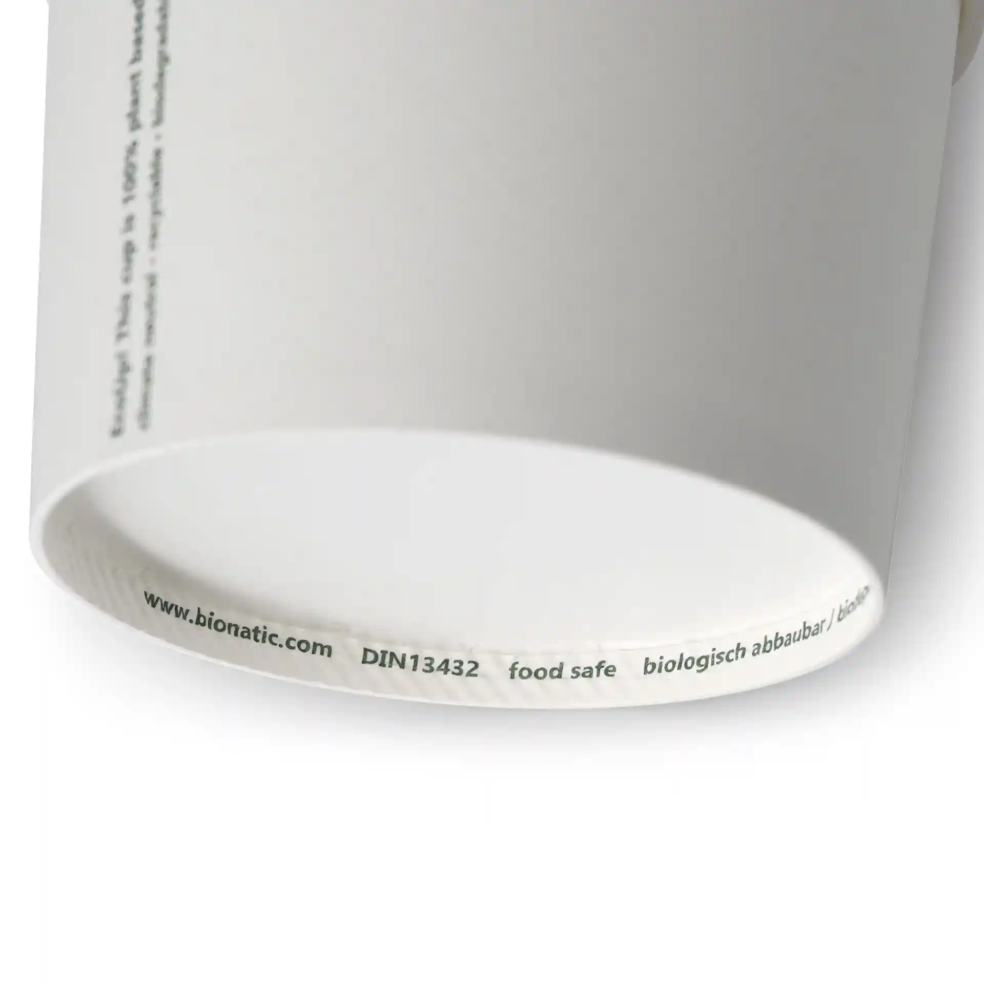 Gobelet en carton blanc pour soupe de forme ronde, montrant le bord inférieur et des marquages imprimés.