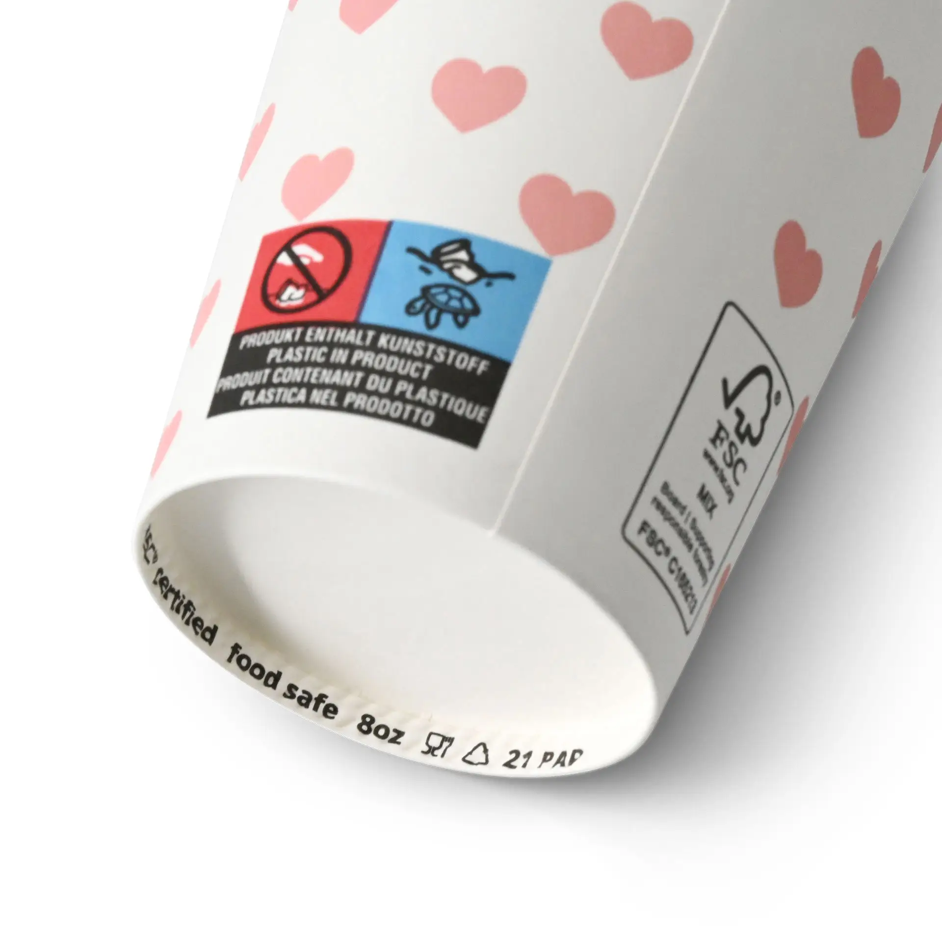 Un gobelet en papier blanc avec des cœurs roses, marqué comme sûr pour les aliments et comportant divers labels au fond.