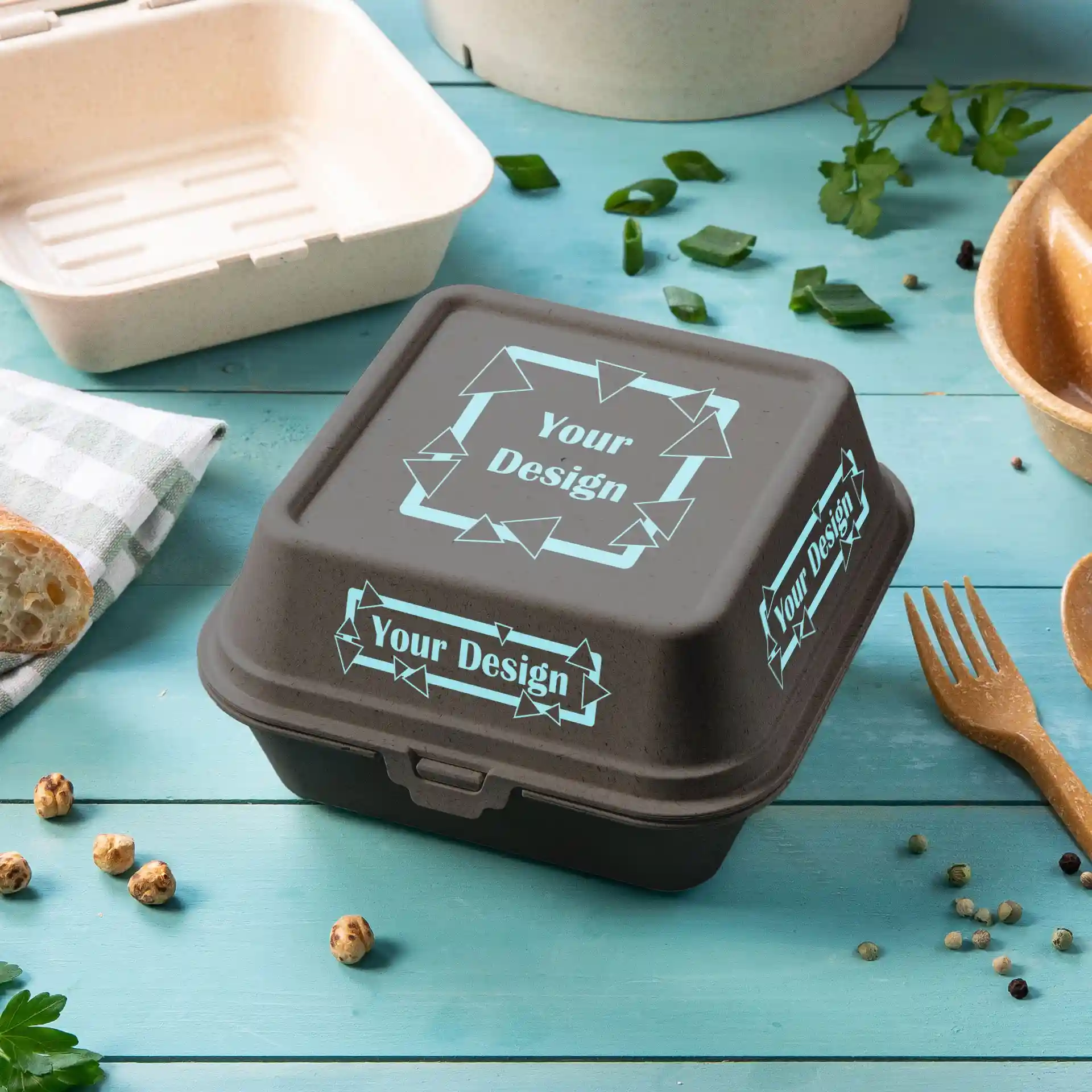 Boîte à burger réutilisable rectangulaire grise imprimée avec un couvercle, présentant un design sur la surface supérieure.